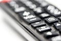Close-up of a TV remote control with focus on the settings button Royalty Free Stock Photo