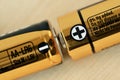 Close-up of two AA size batteries with plus and minus signs - Concept of energy and positive and negative poles