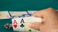 close-up of two aces held in one hand on the green game mat on the right side of the image to leave room for editing, Other cards Royalty Free Stock Photo