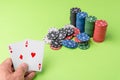 close-up of two aces held in one hand on the green game mat on the right side of the image to leave room for editing, other cards Royalty Free Stock Photo