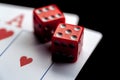 Close-up - Two aces, playing cards and red gaming dices on black table. Royalty Free Stock Photo