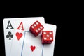 Close-up - Two aces, playing cards and red gaming dices on black table. Royalty Free Stock Photo