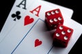 Close-up - Two aces, playing cards and red gaming dices on black table. Royalty Free Stock Photo