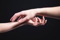 Close-up two beautiful hands of a man and a woman in a gentle gesture of touch. The concept of tenderness of touch and Royalty Free Stock Photo