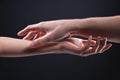 Close-up two beautiful hands of a man and a woman in a gentle gesture of touch. The concept of tenderness of touch and