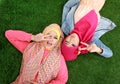 Close up two beautiful happy muslim woman lying on grass Royalty Free Stock Photo