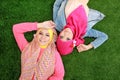 Close up two beautiful happy muslim woman lying on grass Royalty Free Stock Photo