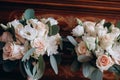 Close up of two beautiful modern and stylish wedding bouquet of white, pink roses and eucalyptus greenery on wooden background. Royalty Free Stock Photo