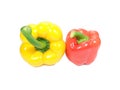 Close-up of two bell peppers, yellow and red with green stem isolated on white background Royalty Free Stock Photo