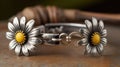 a close up of two bracelets with flowers on them on a wooden surface with a wooden background and a wooden chair in the Royalty Free Stock Photo