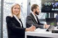 Close up of two business colleagues at the table in modern office room, working together with digital tablet and papers Royalty Free Stock Photo