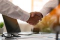 A close up of two business men holding hands, agreeing to work together, or congratulating each other. Business People Shaking Han Royalty Free Stock Photo