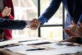 Close-up two business men holding hands, Two businessmen are agreeing on business together and shaking hands after a successful