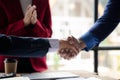 Close-up two business men holding hands, Two businessmen are agreeing on business together and shaking hands after a successful