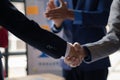 Close-up two business men holding hands, Two businessmen are agreeing on business together and shaking hands after a successful