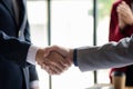 Close-up two business men holding hands, Two businessmen are agreeing on business together and shaking hands after a successful