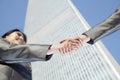 Close up of two business people shaking hands by the china world trade center in Beijing Royalty Free Stock Photo