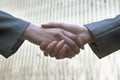 Close up of two business people shaking hands by Chinas world trade center in Beijing Royalty Free Stock Photo