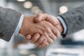 Close-Up of Two Business Professionals Shaking Hands in Modern Office Setting Royalty Free Stock Photo