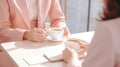 Close-up of two businesswomen sitting in cafe and drinking coffee