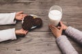 Close up of two children leaving cookies and milk on the table for Santa