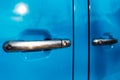 Close-up of two chrome door handle of blue car. Royalty Free Stock Photo