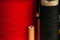 Close-up of two coils with thick threads of red and black for embroidery and needlework in the workshop