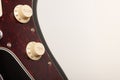 Close up of two conectors on  black electric guitar, studio shoot. Red tortoise shell pickguard Royalty Free Stock Photo