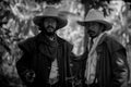 Close up Two cowboys standing and holding short gun