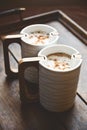 Close-up of two cups of cappuccino