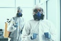 close-up. two disinfectors exit the decontaminated room .