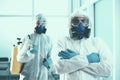 close-up. two disinfectors exit the decontaminated room .