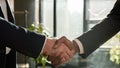 Close up two diverse men shake hands multiracial businessmen conclude successful contract agreement multiethnic business