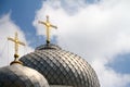 Close-up of the two domes of the church with golden crosses against the blue sky with clouds, soft focus Royalty Free Stock Photo