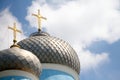 Close-up of the two domes of the church with golden crosses against the blue sky with clouds, soft focus Royalty Free Stock Photo