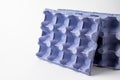 Close-up of two empty blue cartons for eggs, for recycling, white background, horizontal