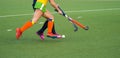 Close up of two field hockey players, challenging eachother for the control and posession of the ball during an intense, competiti Royalty Free Stock Photo