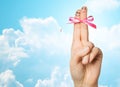 Close up of two fingers tied by pink bow knot Royalty Free Stock Photo