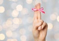 Close up of two fingers tied by pink bow knot Royalty Free Stock Photo