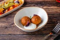 Close-up of two fried croquettes served with creamy dip Royalty Free Stock Photo