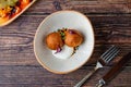 Close-up of two fried croquettes served with creamy dip Royalty Free Stock Photo