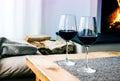 Close-up of two glasses with red wine on table in living room Royalty Free Stock Photo