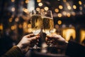 Close up two glasses with sparkling champagne wine in hands. Cheers in restaurant and cafe. Blurred golden bokeh background. Royalty Free Stock Photo