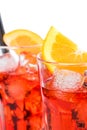 Close-up of two glasses of spritz aperitif aperol cocktail with orange slices and ice cubes isolated on white