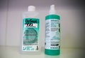 Close up of two green bottles with disinfection agent, white background