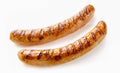 Close-up of two grilled German sausages on white