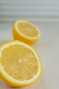 Close-up of two half lemons, with selective focus, on white wooden background and vertical white background Royalty Free Stock Photo