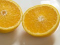 Close up of two halves of sliced juicy orange. Royalty Free Stock Photo