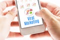 Close up Two hand holding smart phone with Viral Marketing word