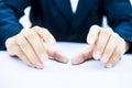 Close up of two hands of a business man wearing blue suit isolated on white trying to save something imagery.